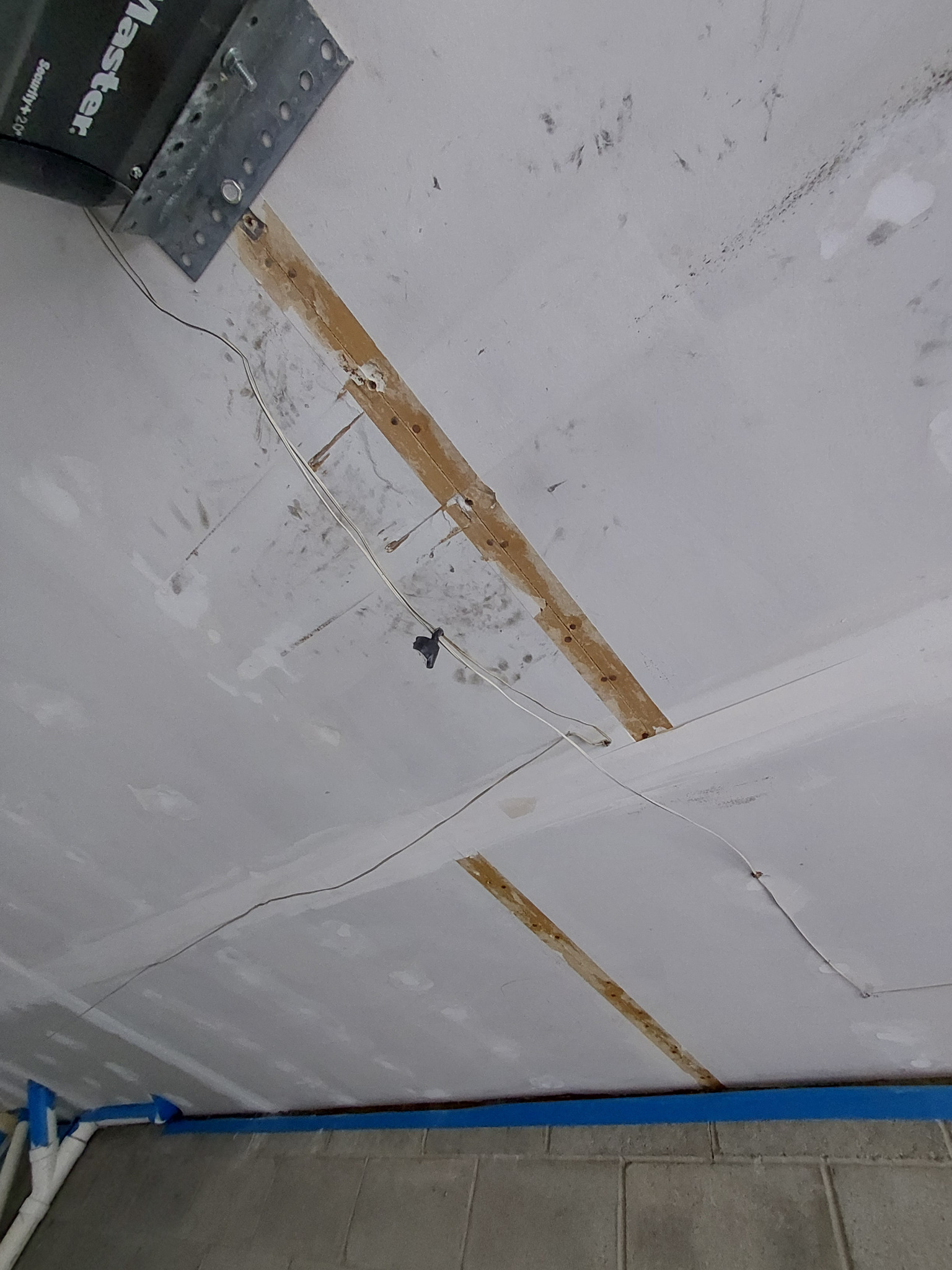 Failed ceiling drywall tape removed from the joint